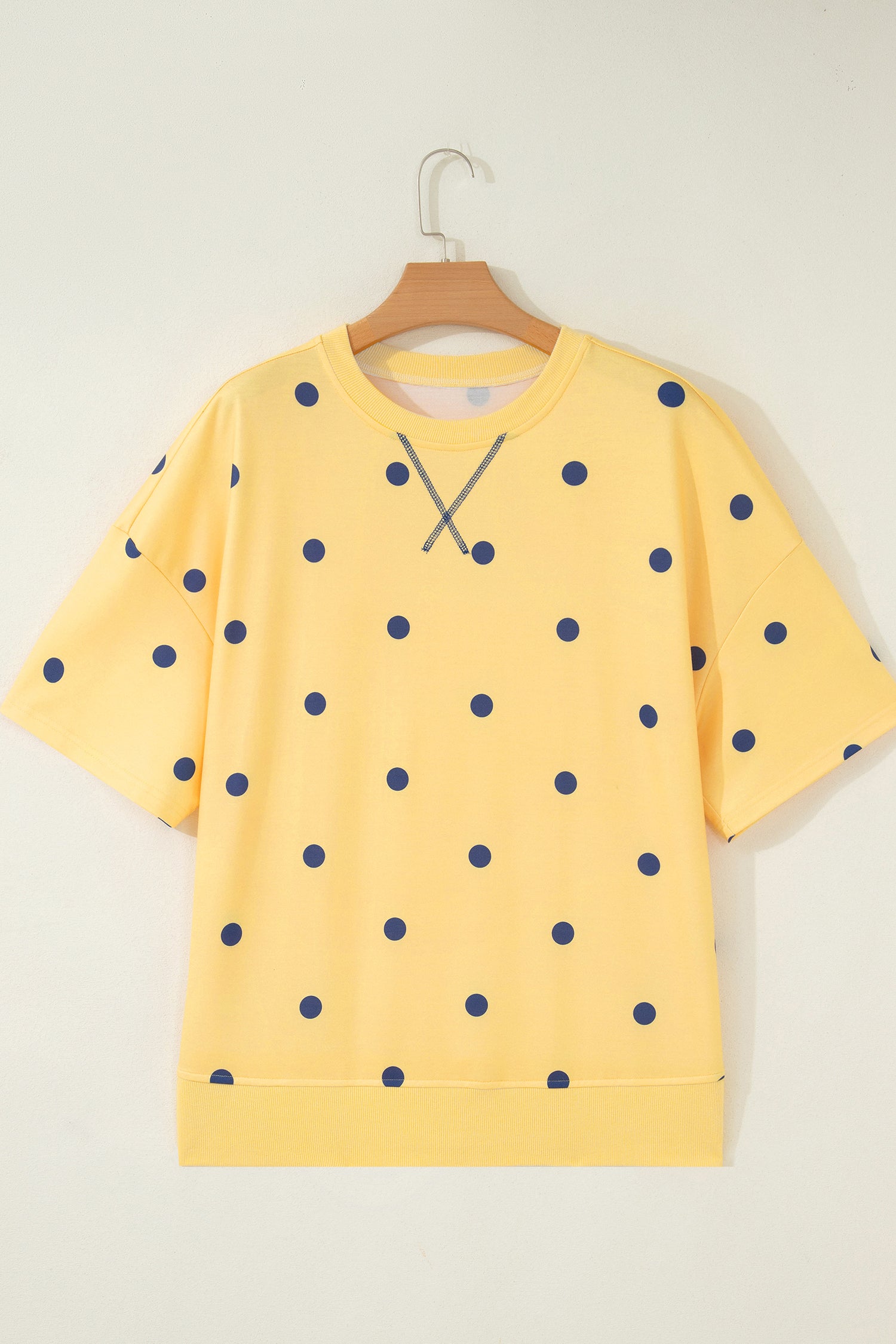 Yellow Polka Dot Print Crossed Seam Detail Oversize Tee amarelo com estampa de bolinhas azuis e detalhe cruzado na costura, ideal para complementar looks casuais.