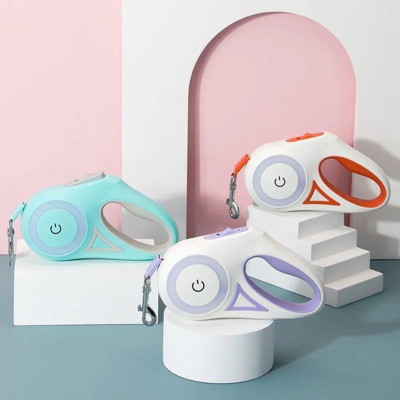 Três Automatic Retractable Lighting Dog Leash em cores pastel, apresentando design ergonómico e moderno, ideais para passeios seguros e com iluminação integrada.