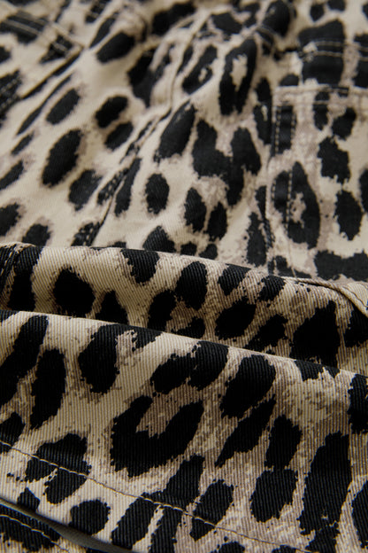 Pormenor do padrão leopard print em tons marrons e pretos sobre tecido denim no Brown Retro Leopard Print Lace-up Elastic Waistband Mid Rise Denim Shorts, ideal para um estilo retro e casual.