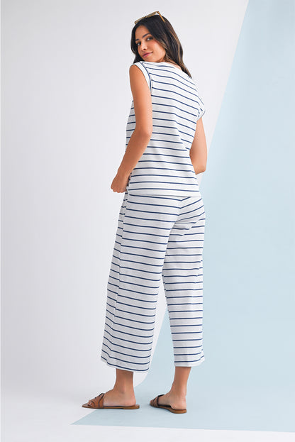 Mulher de costas vestindo Sail Blue Casual Striped Tee and Wide Leg Pants Set branco com riscas azuis, casual, em ambiente claro, transmitindo estilo e conforto.